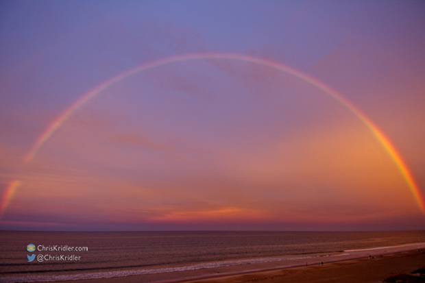 A rainbow glows in the sunset-orange sky at Indialantic, Florida, on Aug. 16, 2014. Photo by Chris Kridler, ChrisKridler.com, SkyDiary.com