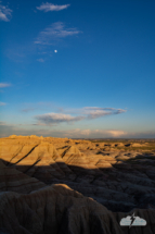 Badlands National Park in South Dakota, with moon.