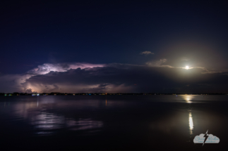 The moon (right) rose above the lightning storms.