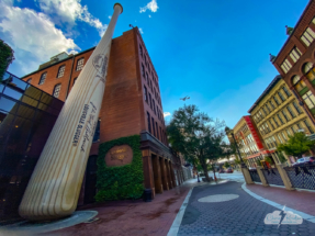 The Louisville Slugger factory, across the street from distilleries, with a jet flying overhead.