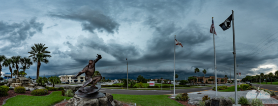A panorama of the shelf cloud with the Kelly Slater statue in the foreground.