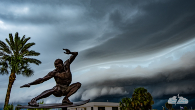 A shelf cloud moves into Cocoa Beach, Florida, on August 26, 2022, as the Kelly Slater statue surfs the sky. 