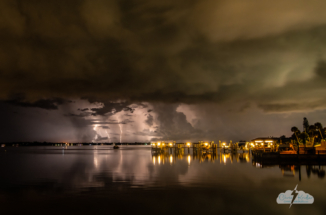 Distant lightning to the south is reflected in the Indian River Lagoon.