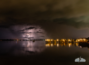 Distant lightning to the south is reflected in the Indian River Lagoon.