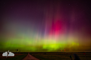 Amazing arcs of green and rays of purple, red and pink at 1:54 a.m. Alethea is the blur in the foreground with her camera.