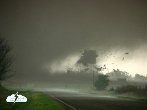 A tornado tears the roof off a house in Attica, Kansas.