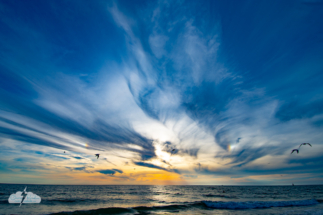 All that&#039;s really left of the halo at sunset: sun dogs on either side of the sun, over the lovely Gulf of Mexico.