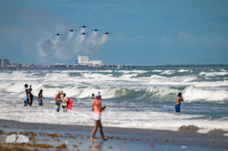 The U.S. Navy Blue Angels fly over the beach.