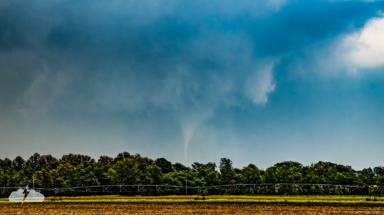 Partially obscured by rain, a white tornado formed. This was 6:46 p.m. CDT.