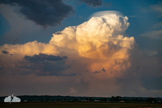 A strong updraft in convection to the east created a pileus cloud atop the storm.