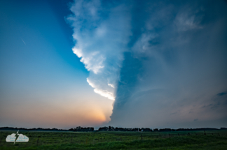 The setting sun created a dramatic shadow from behind the storm's updraft.