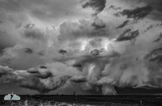 These look like twin tornadoes but are more likely "scudnadoes" - low-hanging clouds.