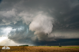 Tornadogenesis. The tornado begins right in front of us (see dirt in the distance). Note: Power lines removed in editing.