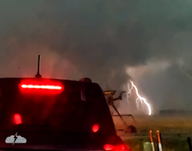Our last look at the tornado (behind a car, of course) before rain obscured it. This is excerpted from a video frame as the rain began to hammer us.