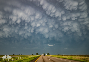 I didn't want to give up the chase and suggested repositioning to another storm - and we found these mammatus on the way. (Shot through the windshield.)