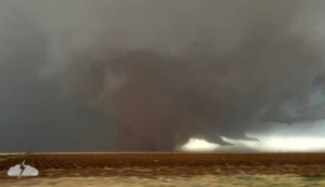 A frame grab from my rough phone video of the tornado to our north as we paralleled it heading east. A "dust wedge" - not that strong but wow! Consider this an impressionistic image, because I did some editing to smooth out parts of the blocky pixellated sky.