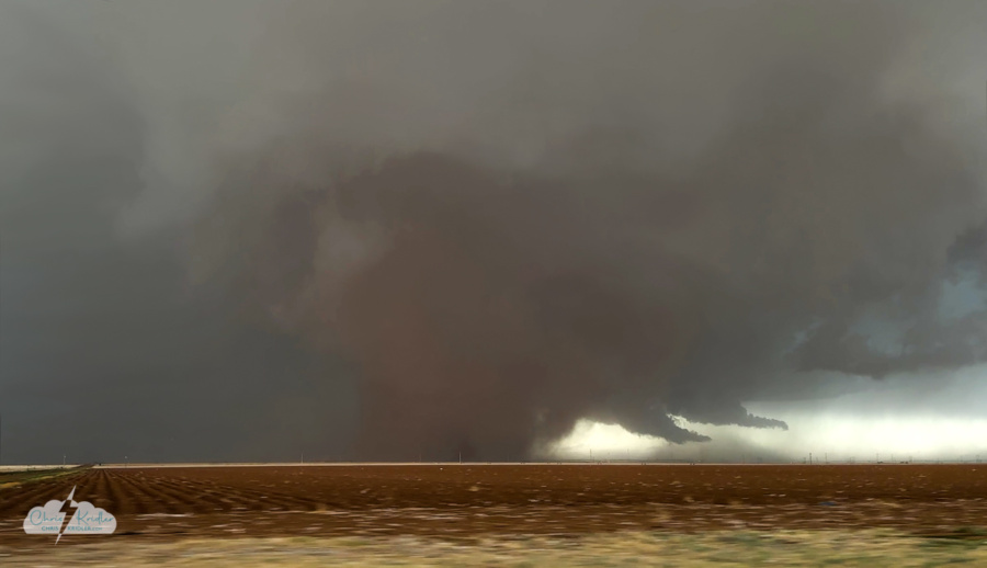 A frame grab from my rough phone video of the tornado to our north as we paralleled it heading east. A "dust wedge" - not that strong but wow! Consider this an impressionistic image, because I did some editing to smooth out parts of the blocky pixellated sky.