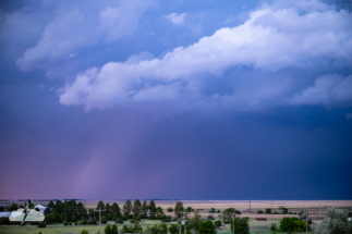 Rain lights up under the storm.