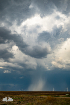 Hail and rain catch the light.