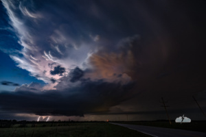 A tornado lit by lightning under the storm!